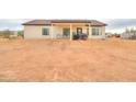 Home's backyard with covered patio, ample space, and desert landscaping at 6293 N Telly Ln, Casa Grande, AZ 85194