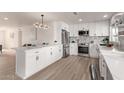 Updated kitchen featuring white cabinetry, stainless steel appliances, and a large island at 102 W Kerry Ln, Phoenix, AZ 85027