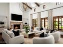 Elegant living room with fireplace, large windows, and comfortable seating at 10234 E Journey Ln, Scottsdale, AZ 85255