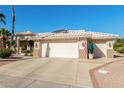 Single-story home with a two-car garage and desert landscaping at 15140 W Gunsight Dr, Sun City West, AZ 85375