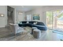 Bright living room featuring a large sectional sofa and sliding glass doors at 3339 E Tonopah Dr, Phoenix, AZ 85050