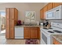 Kitchen with wood cabinets, granite countertops, and white appliances at 3408 W Kimberly Way, Phoenix, AZ 85027