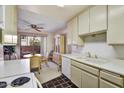 Kitchen with white cabinets, view of dining area and patio at 5525 E Thomas Rd # N1, Phoenix, AZ 85018