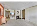 Living room featuring a fireplace and TV area at 5525 E Thomas Rd # N1, Phoenix, AZ 85018