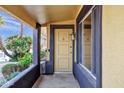 Covered entryway with a light fixture, front door, and a window at 13215 W La Terraza Dr, Sun City West, AZ 85375