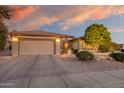 Single-story home with attached two-car garage and landscaped yard at 19521 N Copper Canyon Ct, Surprise, AZ 85387