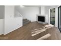Living room with fireplace, wood floors, and large windows at 3228 W Glendale Ave # 118, Phoenix, AZ 85051
