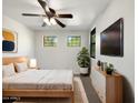 Cozy bedroom with a ceiling fan, ample natural light, and modern furnishings at 4481 E Sundance Ct, Gilbert, AZ 85297