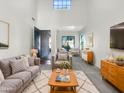 Inviting living room with high ceilings, large windows, and stylish, comfortable furniture at 4481 E Sundance Ct, Gilbert, AZ 85297