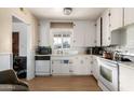 Bright kitchen featuring white appliances and wood-look flooring at 453 S Miller St, Mesa, AZ 85204