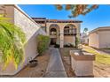 Front yard with walkway, landscaping, and inviting entryway at 7385 E Pleasant Run, Scottsdale, AZ 85258