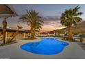 Inviting freeform pool with palm trees and outdoor seating at 2449 W Sunrise Dr, Phoenix, AZ 85041