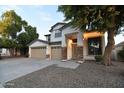 Charming two-story residence with a three-car garage, mature trees, and a welcoming entryway at 8775 W Lane Ave, Glendale, AZ 85305