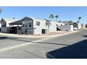 Corner lot location in a community with similar homes, visible mountains, and palm trees at 99 S Kaoline Dr, Apache Junction, AZ 85119