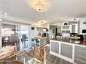 Bright kitchen with ample cabinets, light countertops, and access to the back patio at 99 S Kaoline Dr, Apache Junction, AZ 85119
