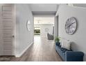 Open entryway with tile floors, bench seating, and view to living room at 10157 E Texas Ave, Mesa, AZ 85212