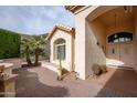 Front entry with double doors, brick patio, and arched entryway at 16068 W Edgemont Ave, Goodyear, AZ 85395
