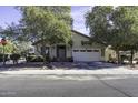 Inviting single-story home exterior with a two-car garage and lush landscaping at 3018 N Regal Ct, Casa Grande, AZ 85122