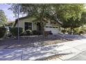 Attractive single-story residence with a two-car garage and mature trees at 3018 N Regal Ct, Casa Grande, AZ 85122