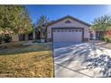 Single-story residence with a two-car garage, front yard landscaping, and a cozy atmosphere at 3335 E San Angelo Ave, Gilbert, AZ 85234