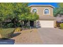 Two-story home with attached two-car garage, desert landscaping, and a paved driveway at 4208 E Tether Trl, Phoenix, AZ 85050