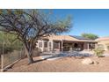 Covered patio with solar panels, outdoor seating, and a desert landscape at 4889 S Nighthawk Dr, Gold Canyon, AZ 85118