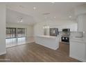 Spacious kitchen with island, stainless steel appliances, and hardwood floors at 501 E Desert Hills Estate Dr, Phoenix, AZ 85086