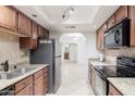 Updated kitchen featuring granite countertops and stainless steel appliances at 8500 E Indian School Rd # 129, Scottsdale, AZ 85251