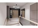 Welcoming entryway with a modern chandelier, wood staircase, and stylish front door at 14521 E Corrine Dr, Scottsdale, AZ 85259