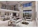Open-concept living room with high ceilings, modern furniture, and a view of the kitchen and dining area at 14521 E Corrine Dr, Scottsdale, AZ 85259