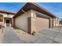 Front exterior view of a single-story home with a two-car garage and walkway at 17774 W Parra Dr, Surprise, AZ 85387