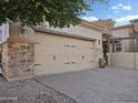 Stone accented home with three-car garage and paver driveway at 6202 E Mckellips Rd # 66, Mesa, AZ 85215