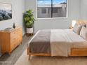 Cozy bedroom with wood furniture, neutral colors, and large window at 11444 N 28Th Dr # 13, Phoenix, AZ 85029