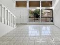 Spacious living room with tiled floors, white walls, and abundant natural light at 11444 N 28Th Dr # 13, Phoenix, AZ 85029