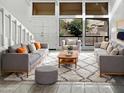 Bright living room with high ceilings, large windows, and modern furniture at 11444 N 28Th Dr # 13, Phoenix, AZ 85029