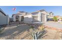 Front exterior of single-story home with desert landscaping and attached garage at 17850 W Villa Chula Ln, Surprise, AZ 85387