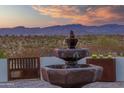 Charming courtyard with a tiered fountain and scenic mountain views at 4450 Black Mountain Rd, Wickenburg, AZ 85390