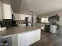 Kitchen with white shaker cabinets, stainless steel appliances, and an island at 6124 N Florence Ave, Litchfield Park, AZ 85340