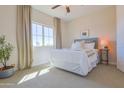 Bright bedroom with large window, neutral carpet, and a cozy bed at 1365 E Avenida Ellena Ln, Casa Grande, AZ 85122