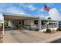 Charming manufactured home with covered carport and welcoming front porch at 2233 E Behrend Dr # 146, Phoenix, AZ 85024