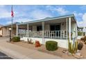 Attractive manufactured home with a covered porch and desert landscaping at 2233 E Behrend Dr # 146, Phoenix, AZ 85024