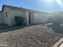 Front exterior view of the single-story home with a gravel yard and some shrubs at 2605 E 10Th St, Tempe, AZ 85288