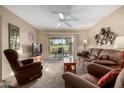 Living room with sliding glass doors leading to the patio and golf course views at 625 S Desert Flower Dr, Mesa, AZ 85208