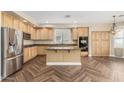 Kitchen features wood cabinetry, granite countertops, and stainless steel appliances at 15835 W Desert Mirage Dr, Surprise, AZ 85379