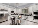 Modern kitchen with granite island, stainless steel appliances, and white cabinets at 20171 N Bustos Way, Maricopa, AZ 85138