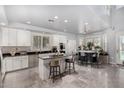 Modern kitchen with granite island, stainless steel appliances, and white cabinets at 20171 N Bustos Way, Maricopa, AZ 85138