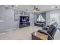 Living room featuring a ceiling fan, recessed lighting, leather furniture, and tile flooring at 2957 E Melrose St, Gilbert, AZ 85297