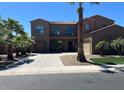 Attractive two-story home with palm trees, a paved driveway, and a three-car garage at 3333 E Powell Pl, Chandler, AZ 85249