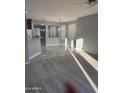 Living room with gray walls, carpet flooring and an open floor plan at 13137 W Stella Ln, Litchfield Park, AZ 85340