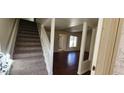 Carpeted stairway leading to a living room with wood-look flooring at 1342 W Emerald Ave # 353, Mesa, AZ 85202